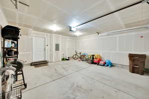 Garage with electric panel and a garage door opener