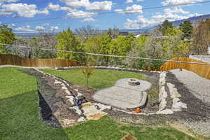 Amazing terraced  yard with paver patio, full fencing and boulder retaining walls.