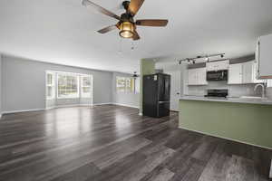 Sleek white cabinets, wood look flooring, stainless steel appliances, pantry and included refrigerator.