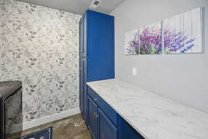 Bathroom with visible vents, vanity, and baseboards