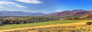 Property view of mountains featuring a residential view and golf course view