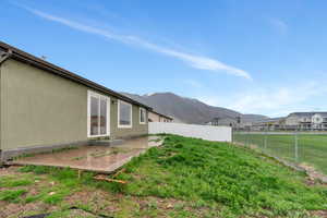 Fenced back yard with large patio