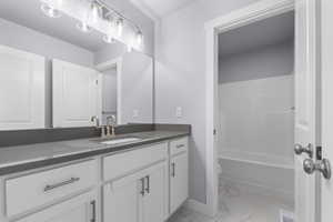 Bathroom with marble finish floor, visible vents, toilet, vanity, and baseboards