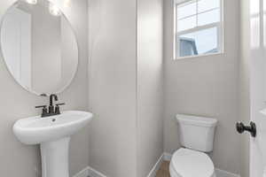 Half bath with toilet and baseboards