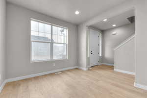 Foyer entrance featuring recessed lighting, light wood-style flooring, visible vents, and baseboards