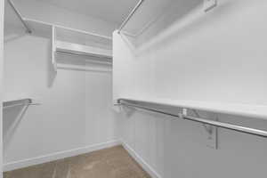 Walk in closet featuring carpet