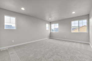 Spare room featuring recessed lighting, visible vents, baseboards, and light colored carpet
