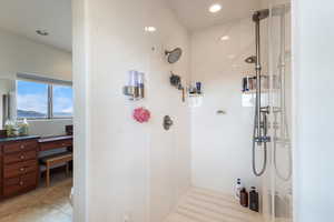 Bathroom with tile patterned flooring, a marble finish shower, and recessed lighting