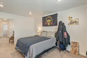 Bedroom featuring baseboards, recessed lighting, a textured ceiling, and carpet