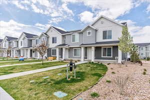 Multi unit property with a front yard and a residential view