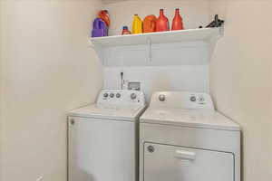 Washroom with washing machine and dryer and laundry area