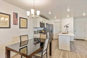 Interior space featuring recessed lighting, a notable chandelier, a textured ceiling, and light wood-type flooring