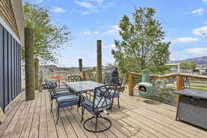 Deck featuring a mountain view and outdoor dining space