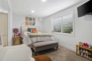 Carpeted bedroom featuring baseboards, visible vents, and recessed lighting