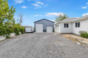 Detached garage featuring fence