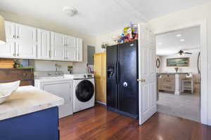 Washroom with recessed lighting, dark wood-type flooring, washer and dryer, cabinet space, and ceiling fan