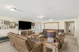 Living area featuring light colored carpet
