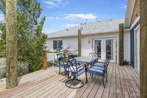 Wooden deck featuring french doors and outdoor dining area