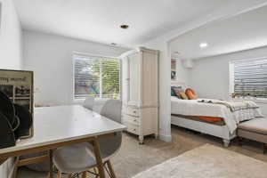 Bedroom with light colored carpet, visible vents, and recessed lighting