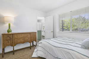 Carpeted bedroom featuring multiple windows