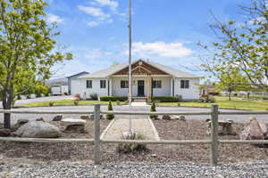 Single story home with roof with shingles and covered porch
