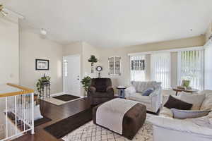 Living area with baseboards and wood-type flooring