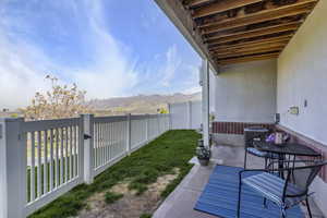 View of yard with a fenced backyard, a mountain view, central AC unit, and a patio area
