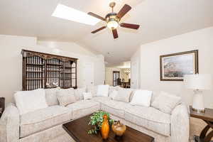 Living area featuring ceiling fan and lofted ceiling