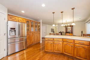Kitchen featuring stainless steel fridge, custom china hutch