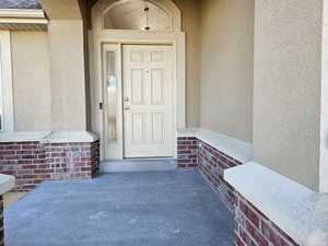 View of exterior entry with stucco siding