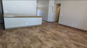 Unfurnished room featuring wood finished floors and baseboards