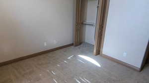 Unfurnished bedroom with carpet and baseboards