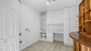Unfurnished office featuring baseboards and light tile patterned floors