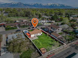 Birds eye view of property with a mountain view and a residential view
