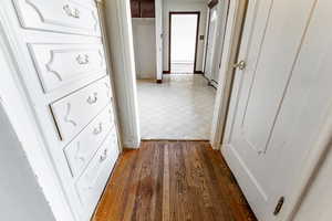 Corridor featuring dark wood-style flooring