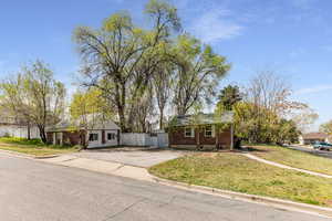 View of front of property with a front lawn and brick siding