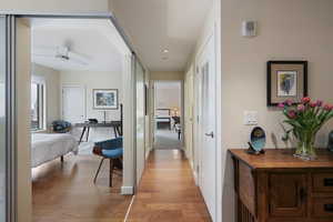Corridor featuring light wood-style flooring