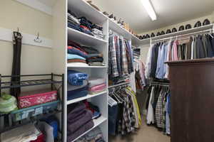 Walk in closet with carpet floors