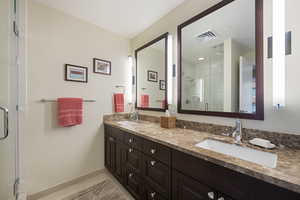 Bathroom with a shower stall, a sink  and double vanity