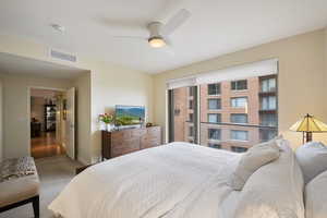 Bedroom with a ceiling fan, and carpet