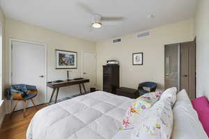 Bedroom featuring a ceiling fan, wood finished floor