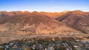View of mountain backdrop featuring nearby suburban area