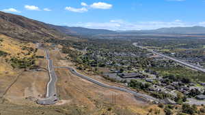 View of property location featuring a mountainous background and nearby suburban area