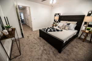 Bedroom featuring baseboards and carpet