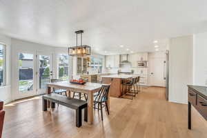 Dining room with a chandelier, light wood-style floors, and recessed lighting