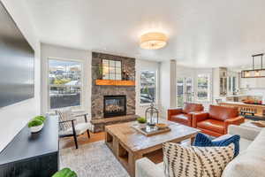 Living area with a fireplace and light wood-style floors