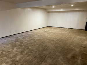 Finished below grade area with baseboards and carpet floors