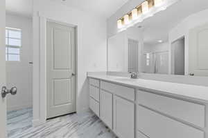 Bathroom with baseboards, visible vents, vanity, and a stall shower