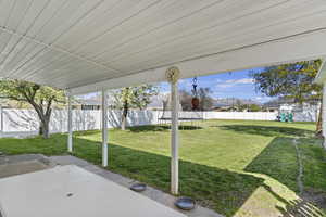 View of patio with a fenced backyard, a mountain view, and a trampoline