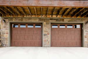 Garage  doors with driveway, stone detail.